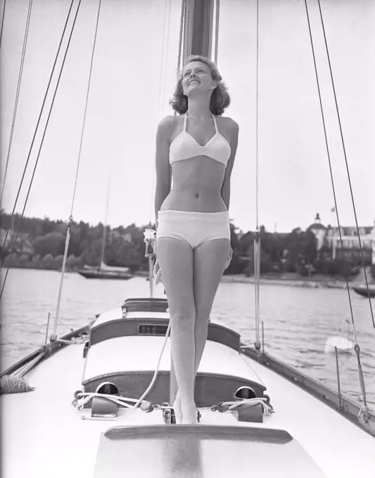 1940s bikinifashion. A swedish young woman in a white bikini on a sailing boat on a summer's day. Sweden 1948. Photo Kristoffersson ref 217a-2. Her name is Haide Göransson, swedish fashion model.