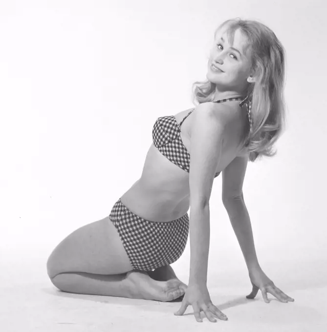1960s bikini fashion. A blonde girl in a photographers studio in a typical 1960s bikini. Sweden 1960s Photo Kristoffersson ref CP73-4
