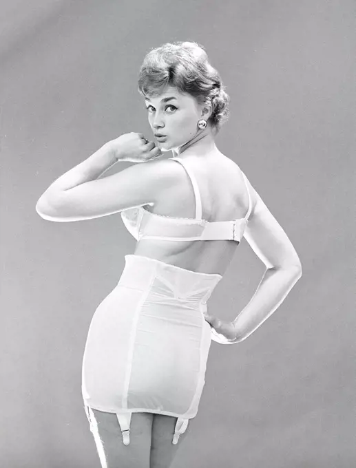 Woman of the 1950s. A woman is posing in typical 1950s underwear and bra. Sweden 1950s. Photo Kristoffersson ref CU68-5. 