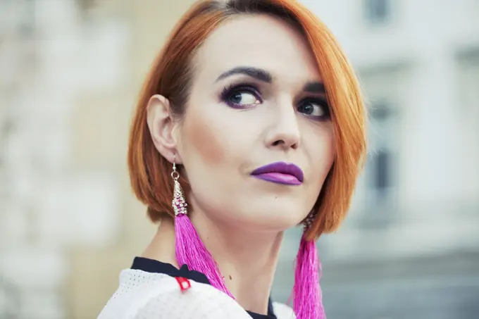 Girl portrait with orange hair and cyclamed earring