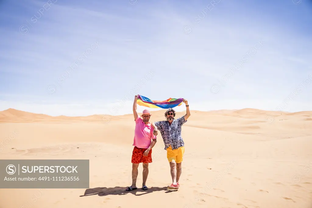 Excited plump gay couple in desert