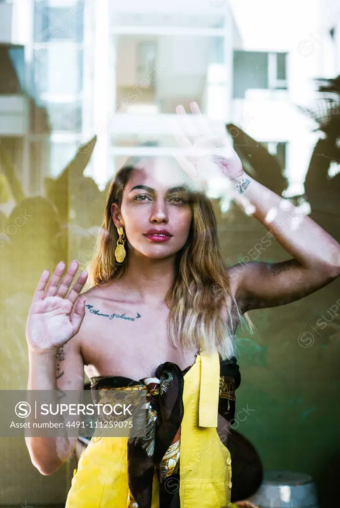 Beautiful stylish woman looking through window