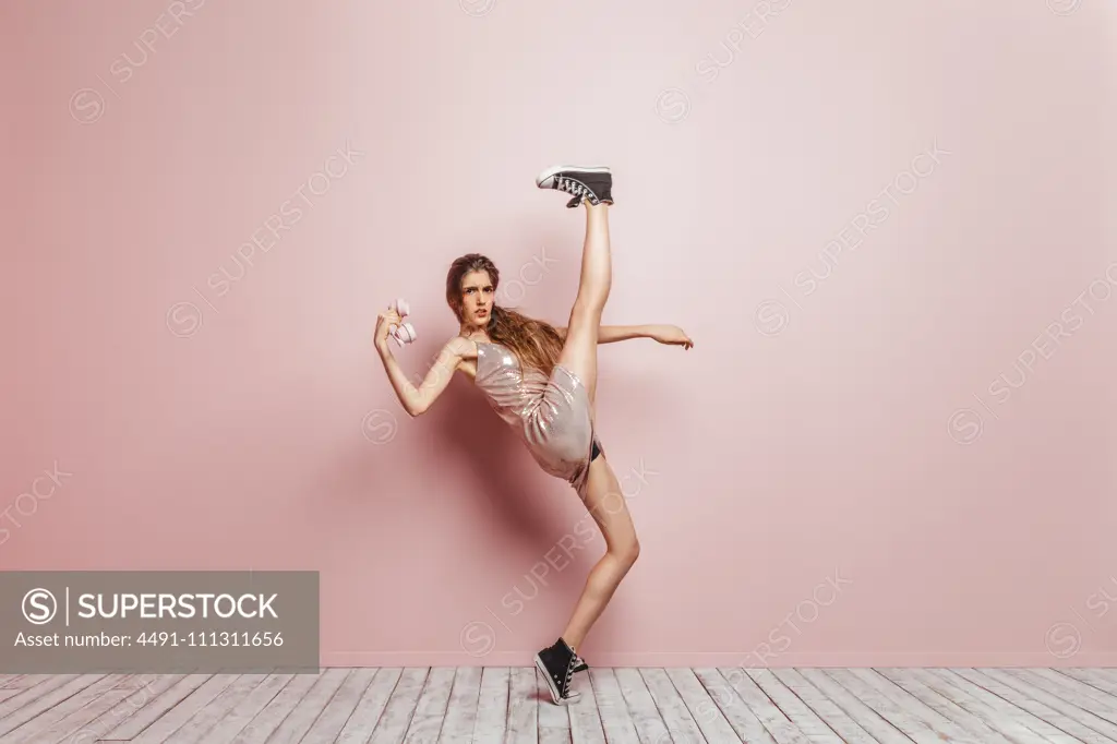 fashion girl with a phone on pink background  millennial