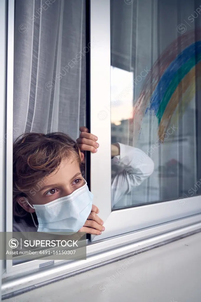 Boy behind window during quarantine