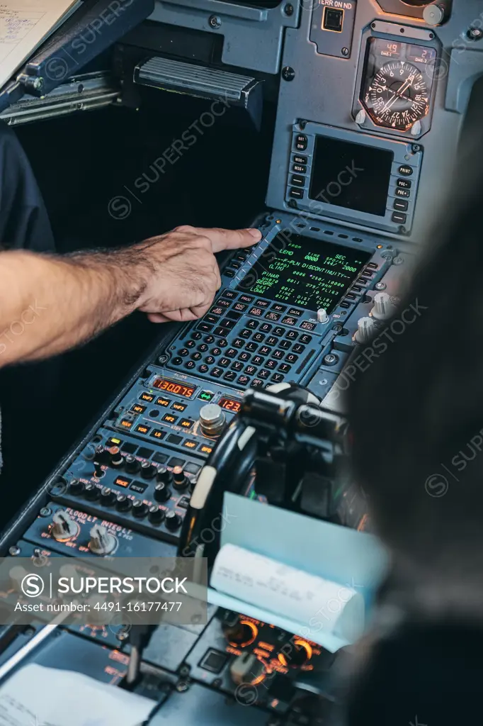 Pilot using flight management system during flight