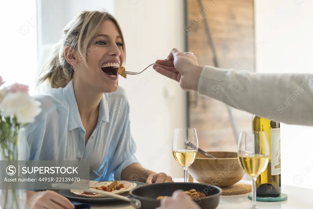 happy young couple having dinner at home