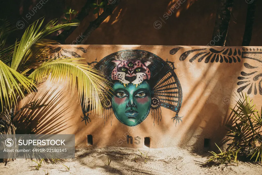 Beautiful creative graffiti on wall of building on tropical beach.