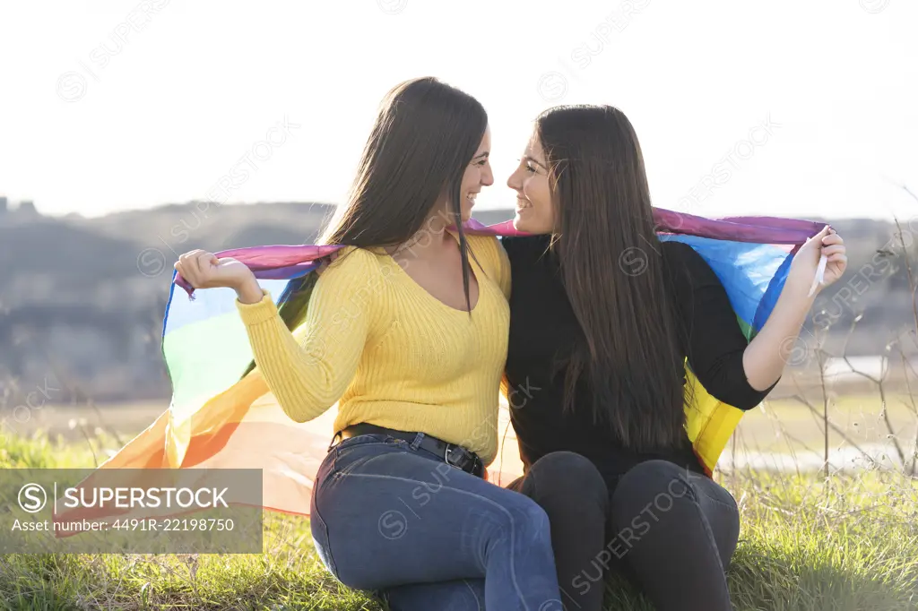 Young girl couple with gay flag