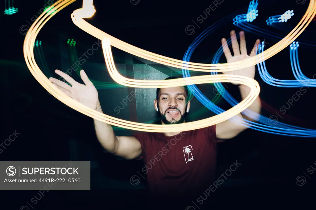 Handsome bearded man dancing in spotlight