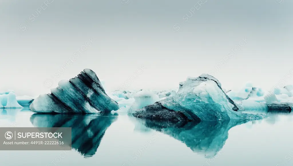 Picturesque view of ice on water surface between snow in winter in Iceland