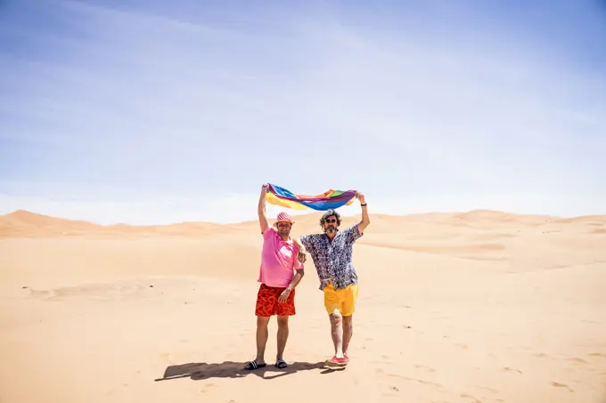 Excited plump gay couple in desert