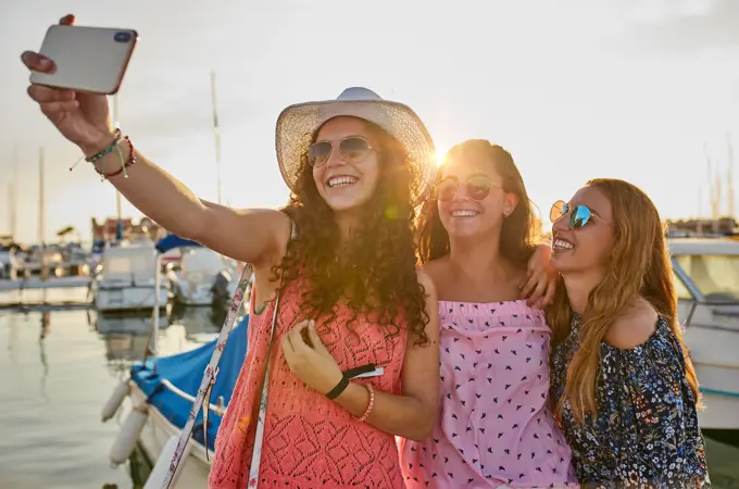 Optimistic fellows bonding and shooting selfie in summer