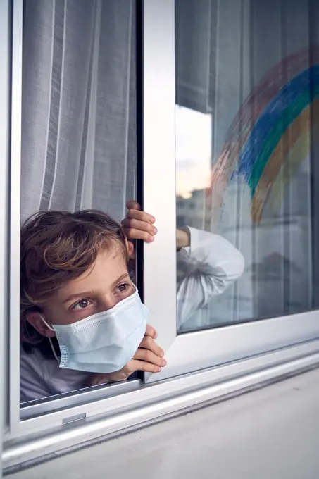 Boy behind window during quarantine