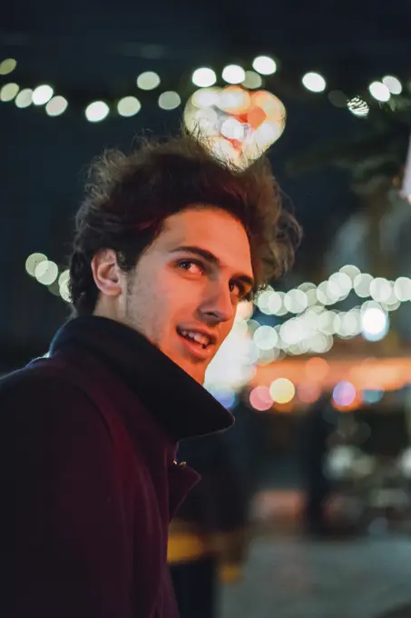 Cheerful man on street at night