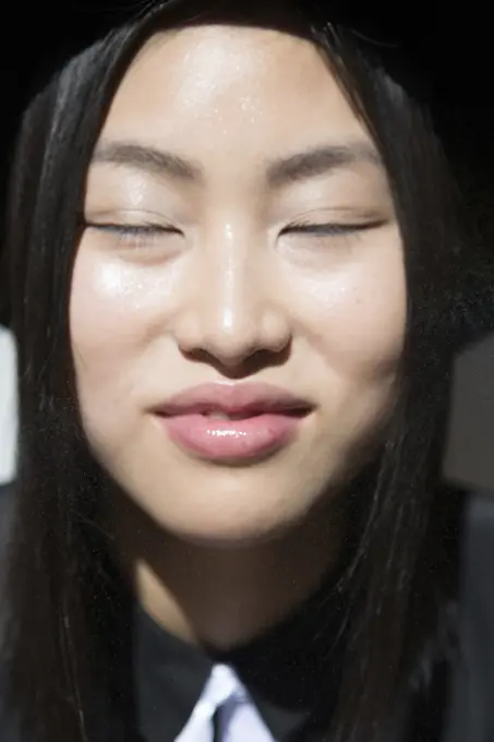 Stylish Asian woman with eyes closed