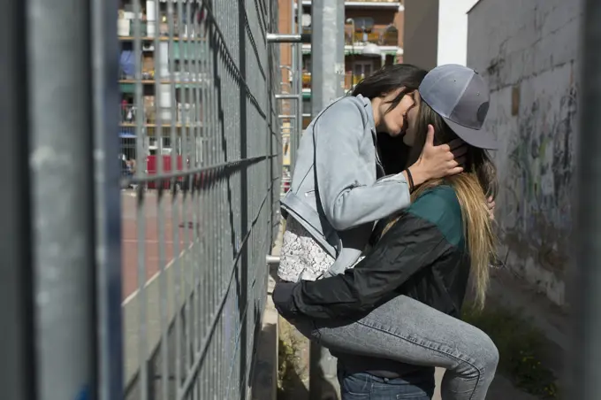 An attractive young lesbian couple on a street 