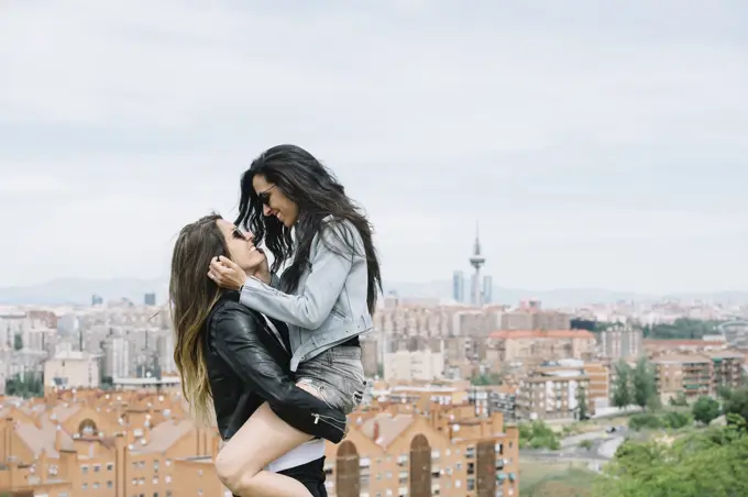 An attractive young lesbian couple on a street 