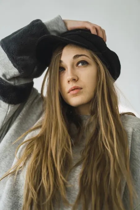 Stylish young girl sitting on bed