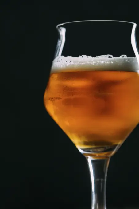 Glass of beer over dark background