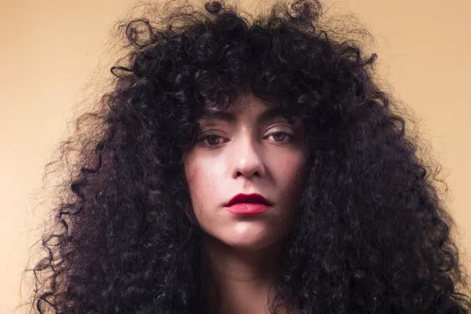 Curly woman in studio