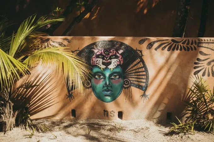 Beautiful creative graffiti on wall of building on tropical beach.