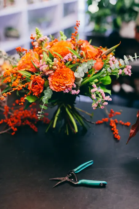 Floral bouquet on the counter in flower shop. Small business, professional occupation, florist.