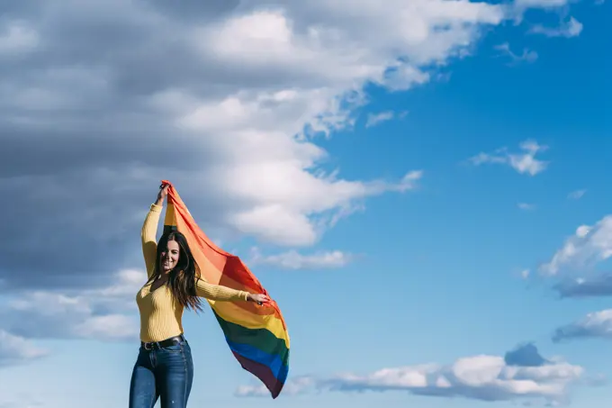 Young woman with gay flag