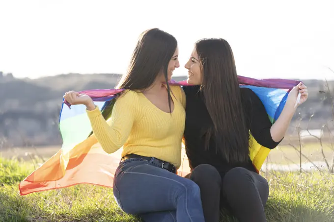 Young girl couple with gay flag