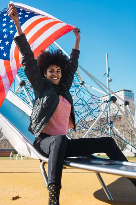 black woman with afro hair and an american flag celebrating the independence day of USA