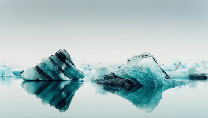 Picturesque view of ice on water surface between snow in winter in Iceland