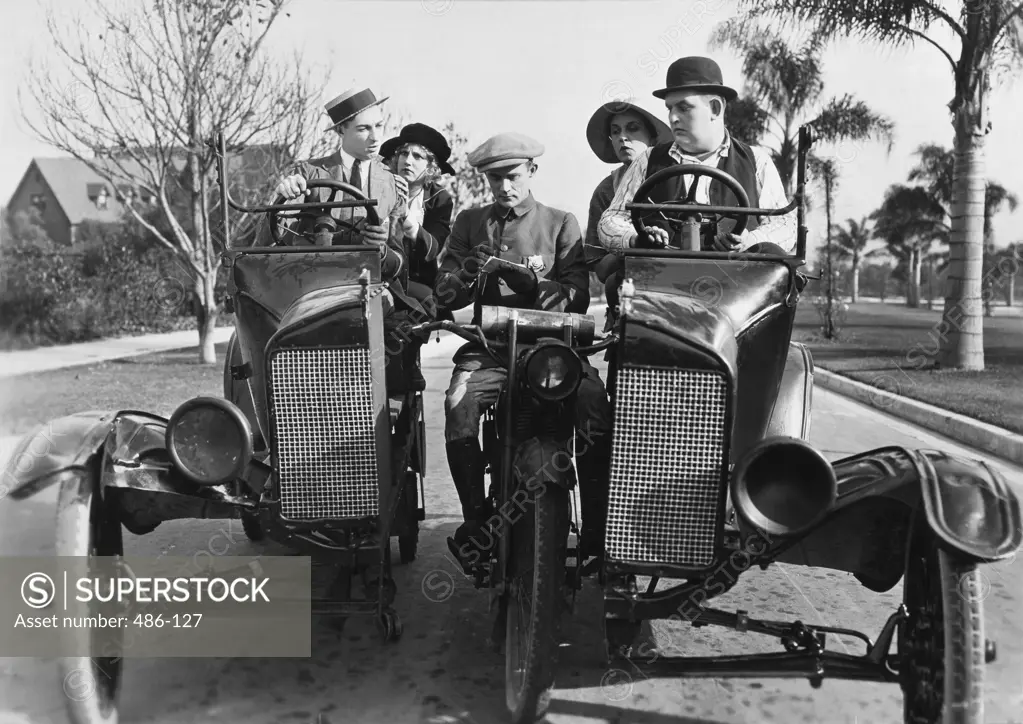 Two mid adult couples getting a speeding ticket