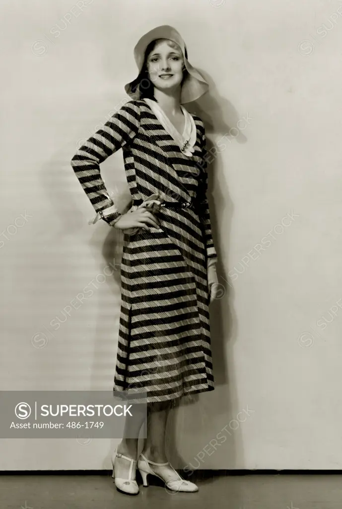 Young woman in striped dress and sun hat, 1931