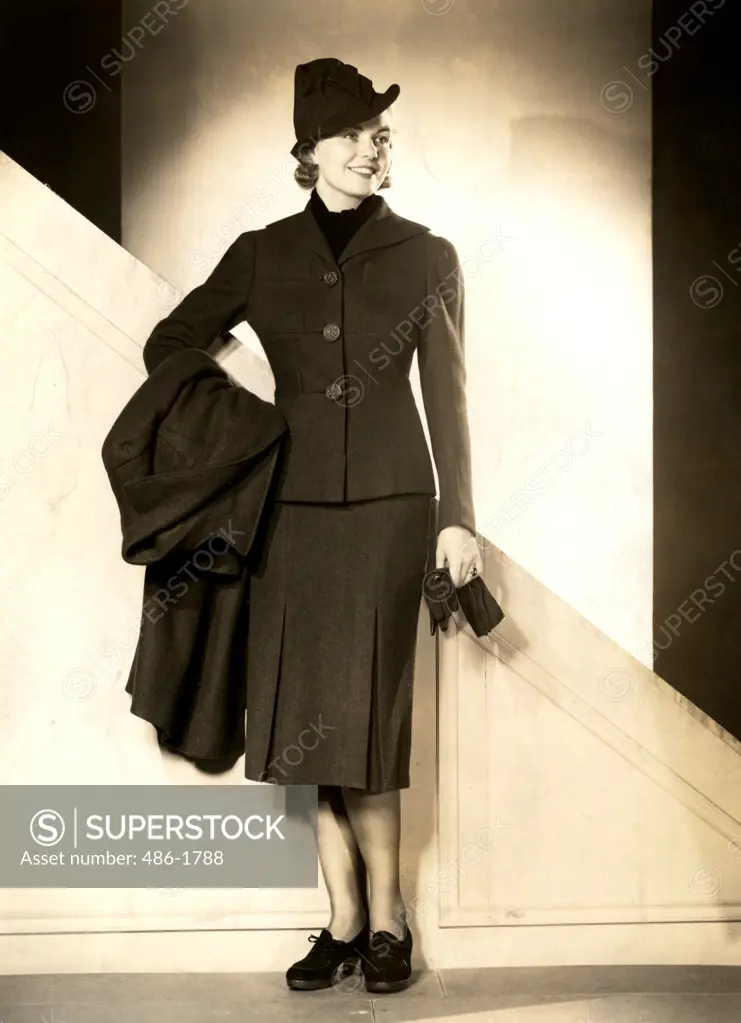 Fashion model posing in winter clothes, studio shot