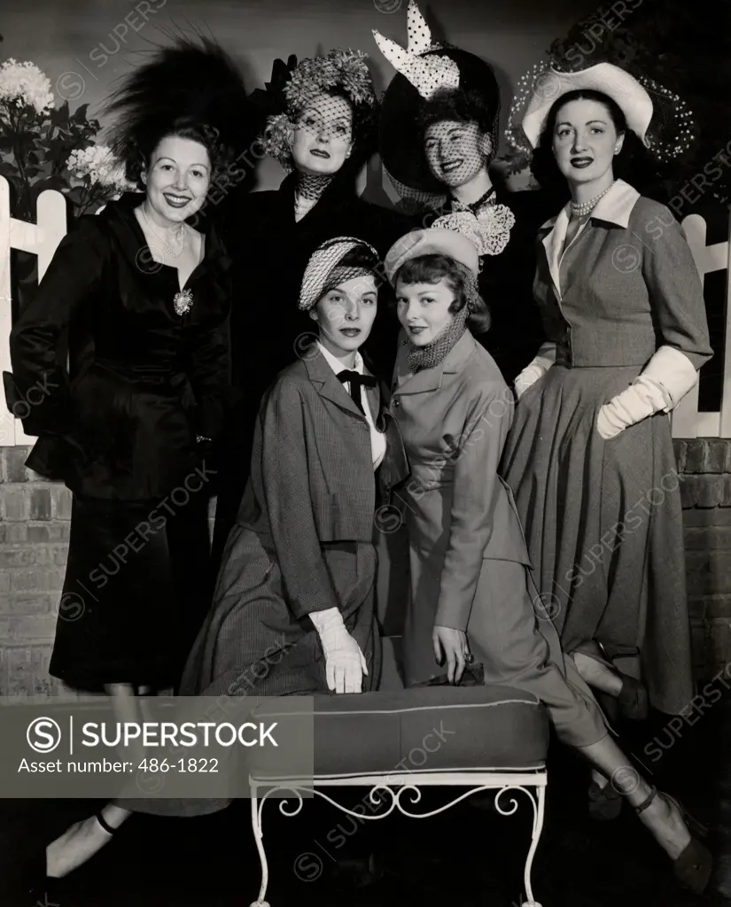 Group of fashion model posing in elegant clothing