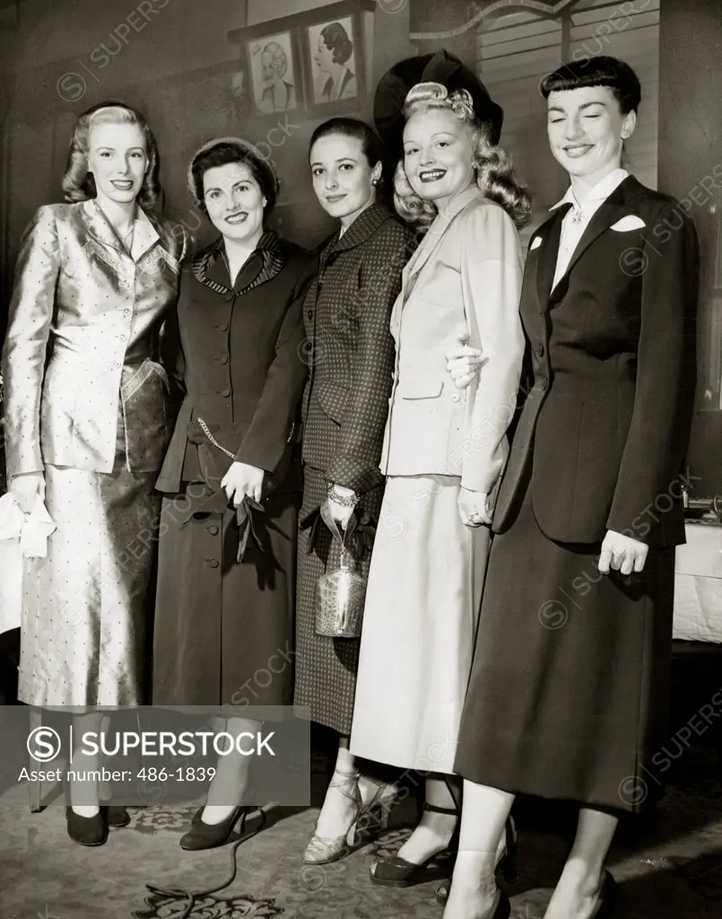 Group of fashion model posing in elegant clothing