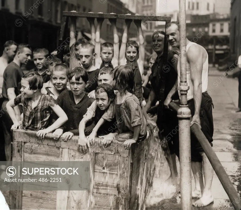 USA, New York City, Swimming Hole In The Middle Of The Street Built By Firemen For West Side Kids