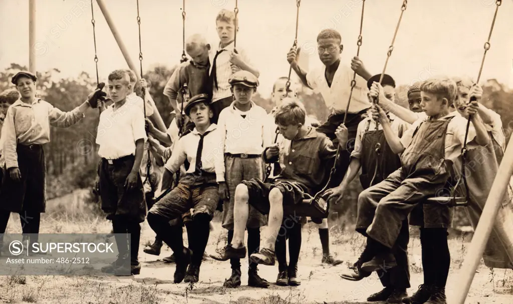 Group of boys playing on swings