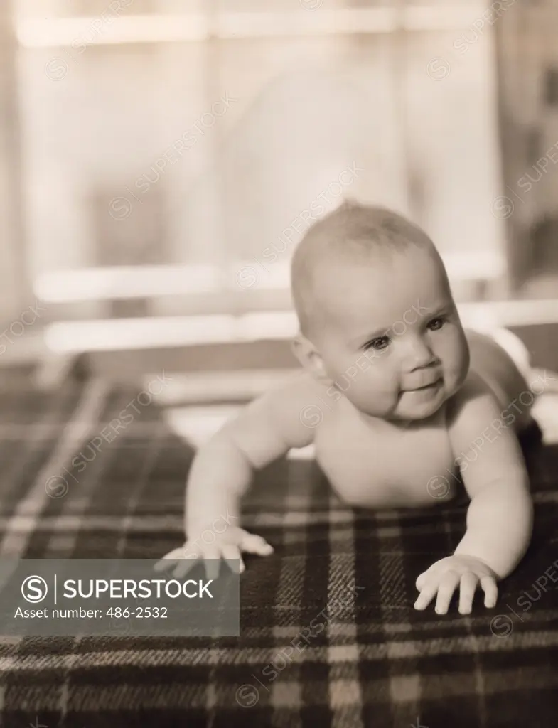 Portrait of baby boy on bed