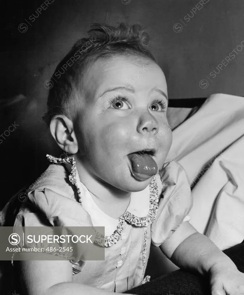 Close-up of girl sticking up tongue