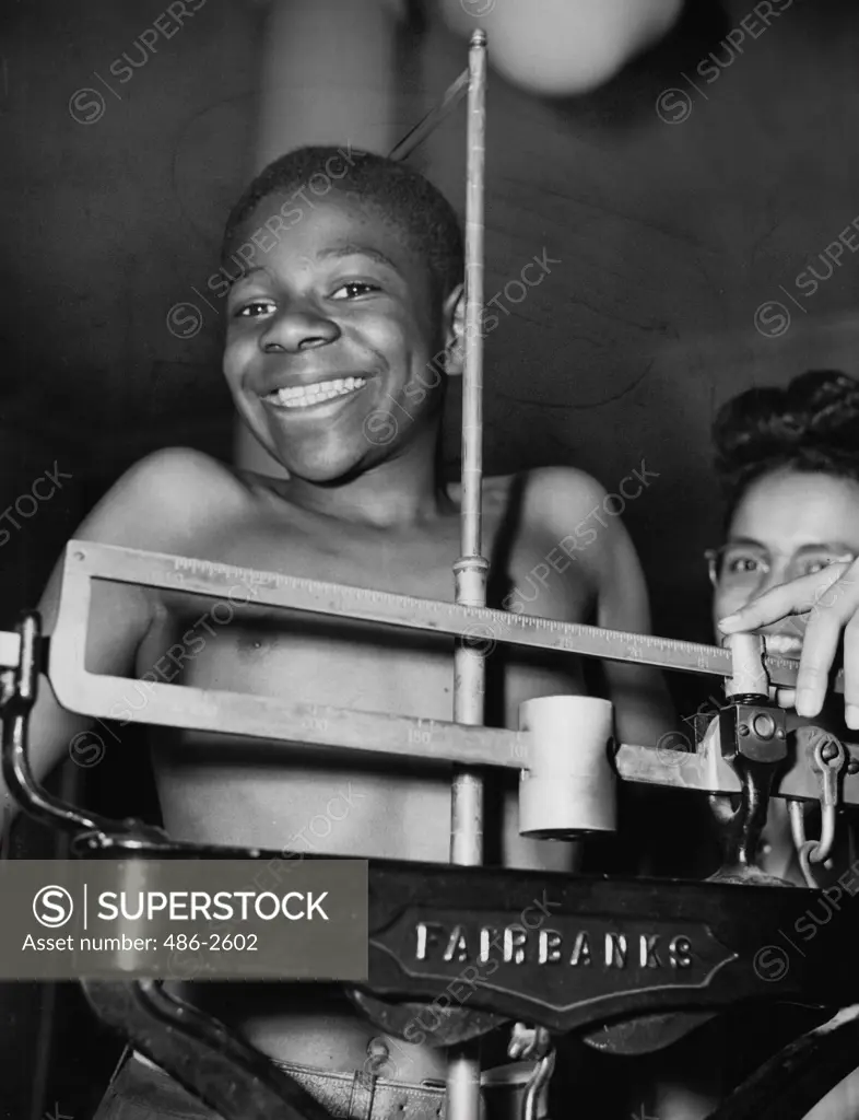 Portrait of boy on weight scale