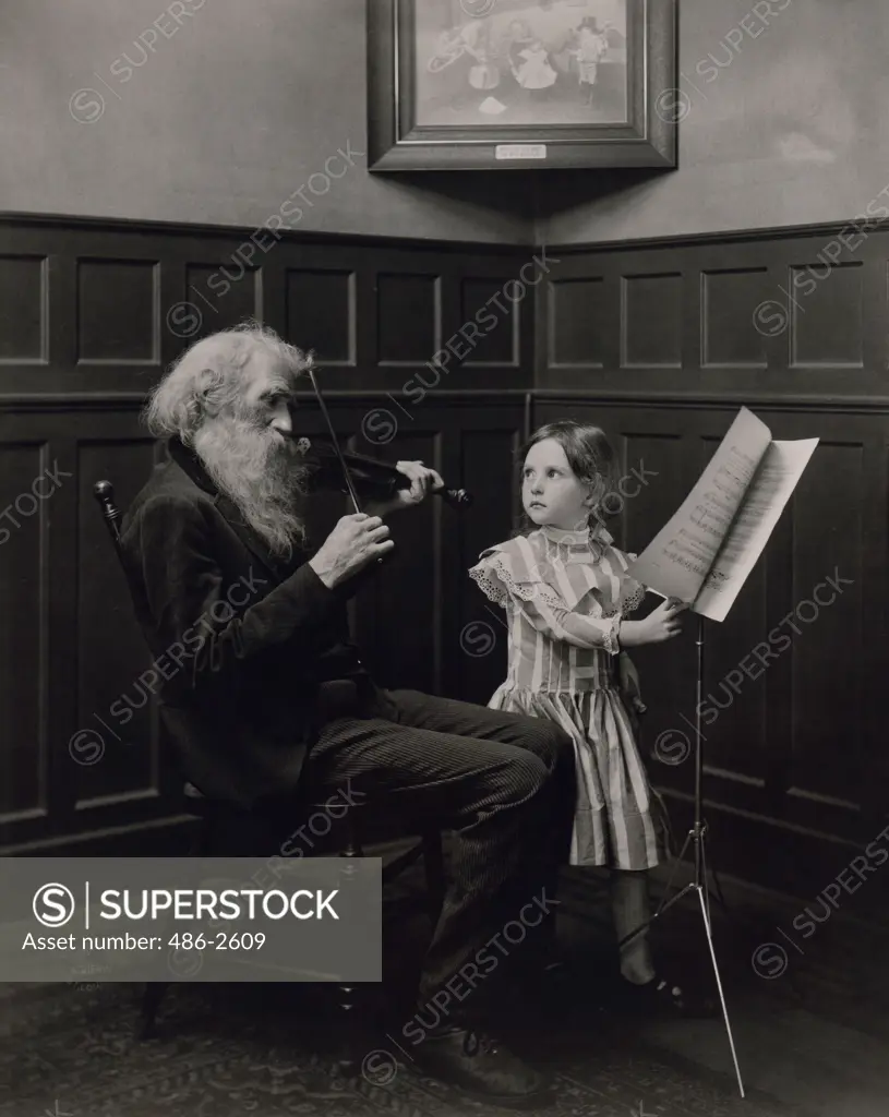 Portrait of man playing violin and girl standing next to him