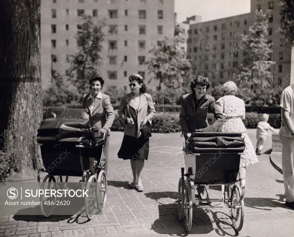 Women pushing baby carriages