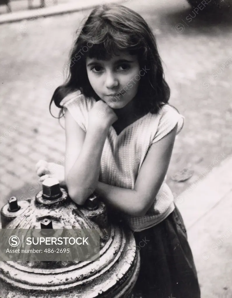 Portrait of teenage girl leaning fire hydrant