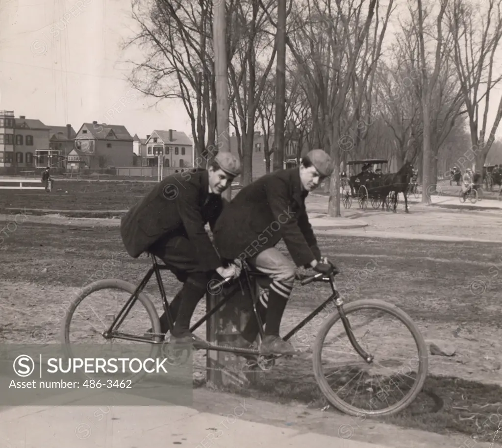 Two men cycling on tandem bicycle