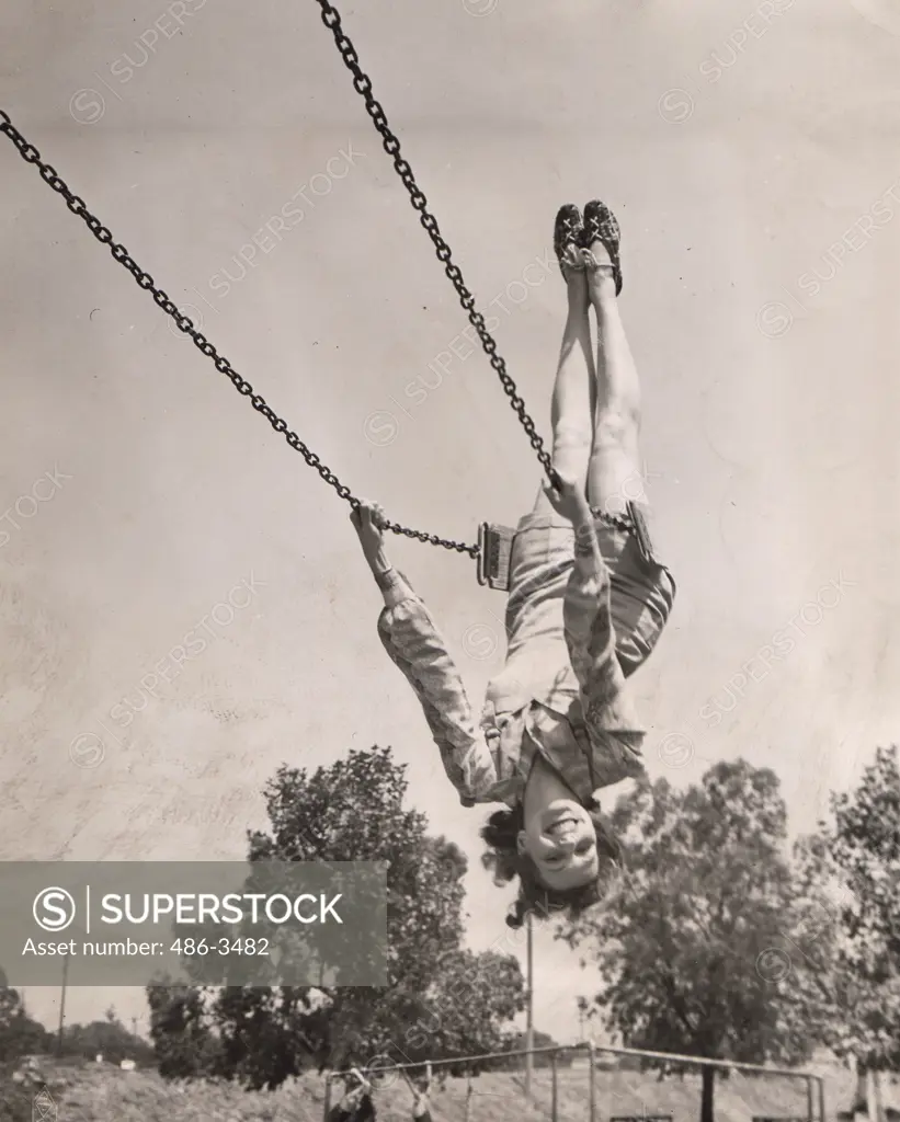 Julie Bishop, who has just completed the feminine lead opposite Errol Flynn in Warner Bros. Northern Pursuit, likes to get her exercise on good old fashioned swings