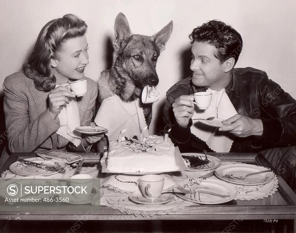 Actors Priscilla Lane and Robert Cummings with dog Gray Shadow, in film ""Saboteur""