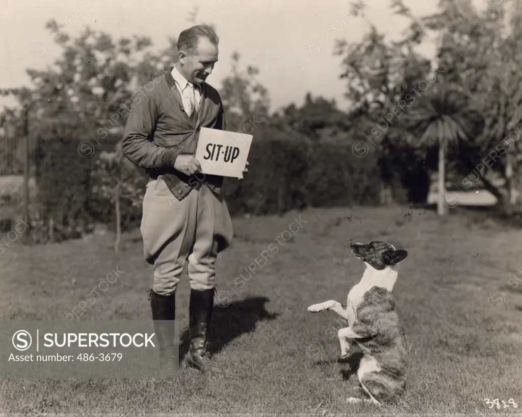 Rennie Renfro giving Buster of MGM Barkies his daily reading lesson