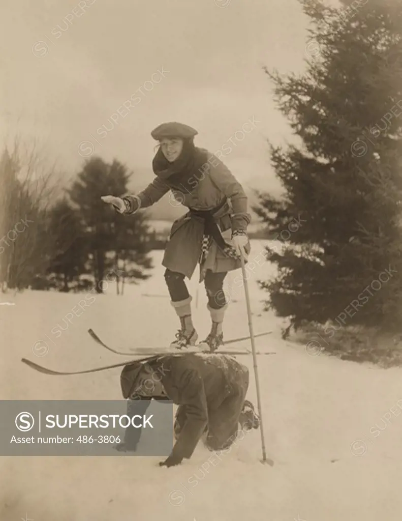 Portrait of Ann Murdock balancing on mans back in skies