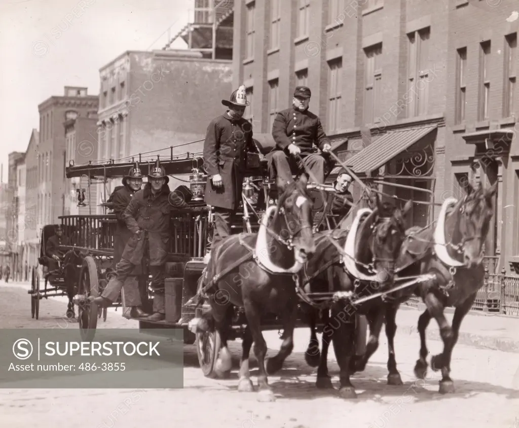 Firemen on old fire engine