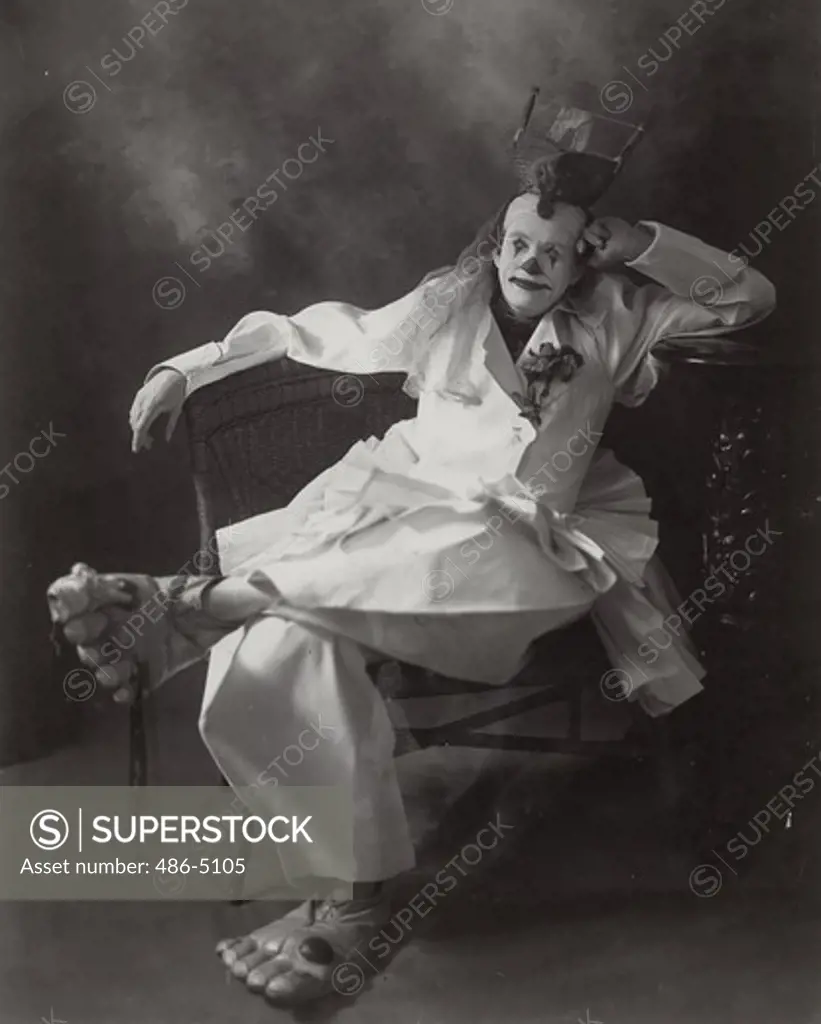 Portrait of clown sitting on chair